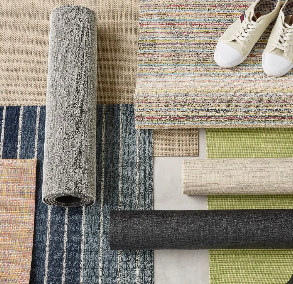 Layered Chilewich mats in blue stripes, gray, charcoal, green and multicolor