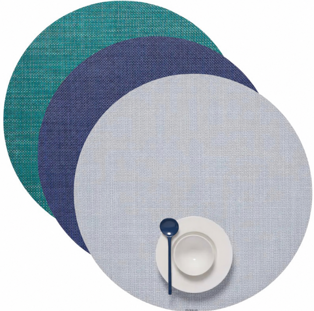 Teal, navy and gray round Chilewich placemats with a navy spoon