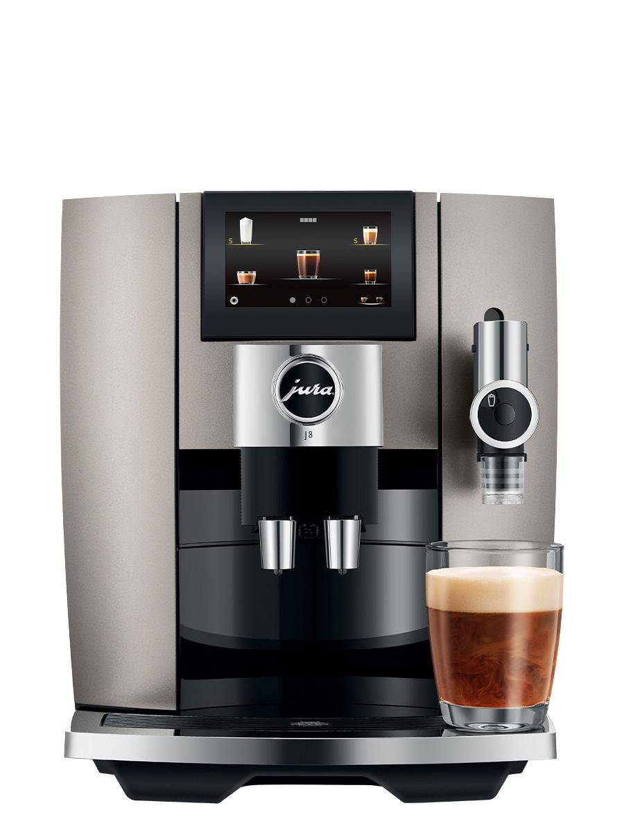 Front view of J8 Midnight Silver including touchscreen display, coffee spouts, drip tray, with a sweet latte in a glass cup