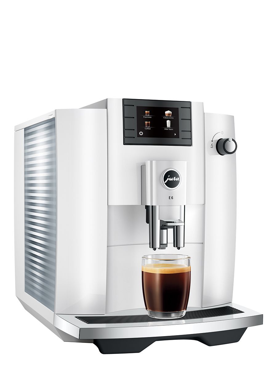 Angled view of Jura E6 Piano White, highlighting the display and sleek white casing. Dispensed coffee on drip tray in clear glass