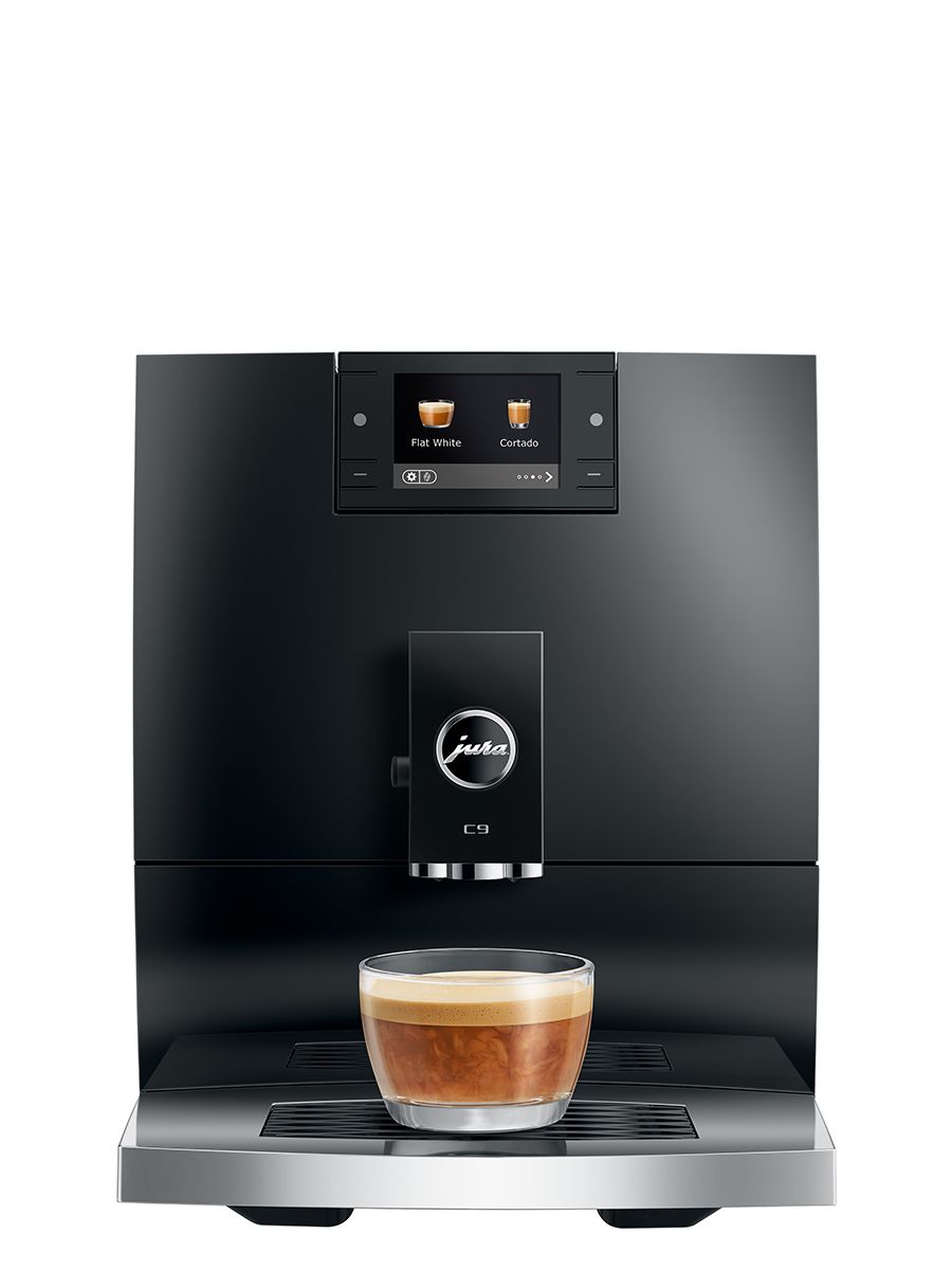 Front view of the JURA C9 Piano Black automatic coffee machine dispensing coffee into a glass cup on the drip tray.