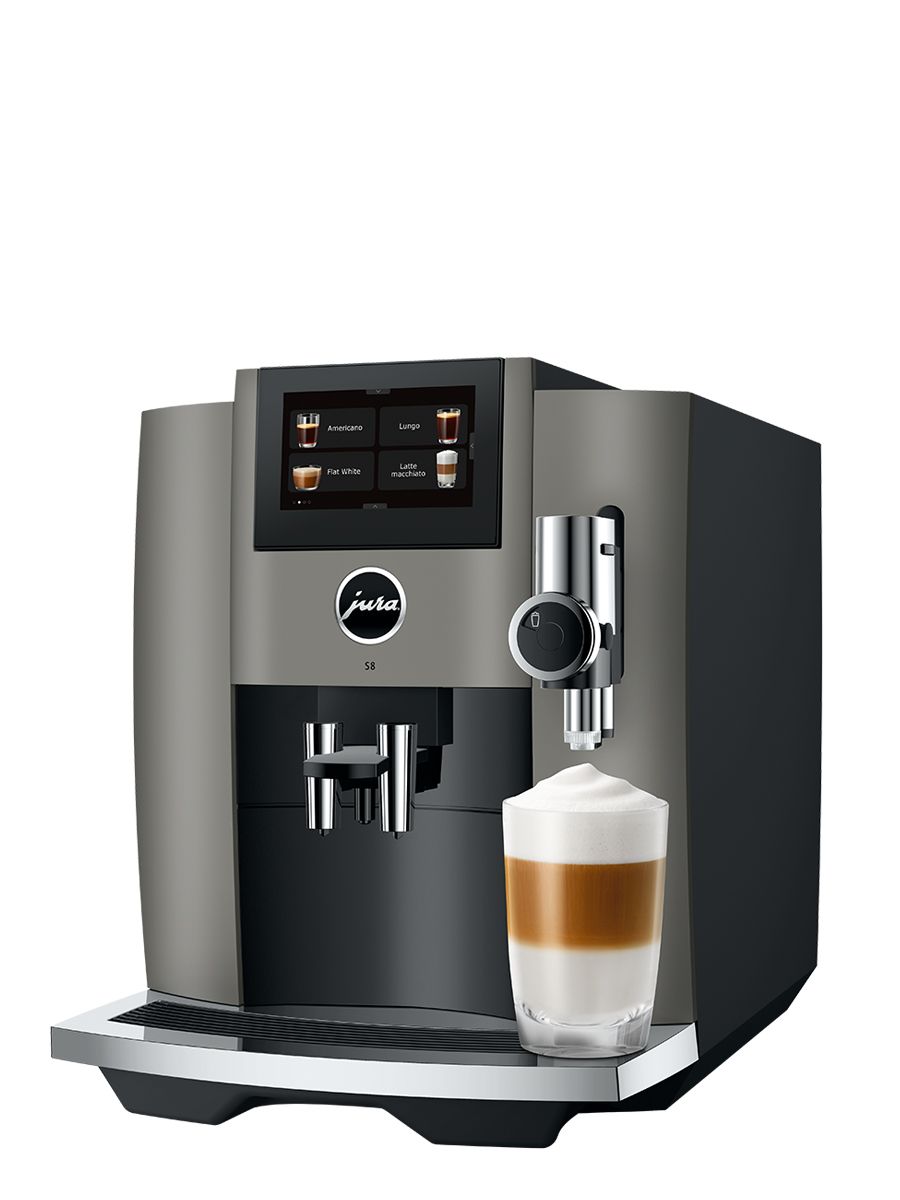 Left side view of S8 Dark inox featuring touchscreen display, drip tray, coffee spouts, with Latte Macchiato in a glass cup