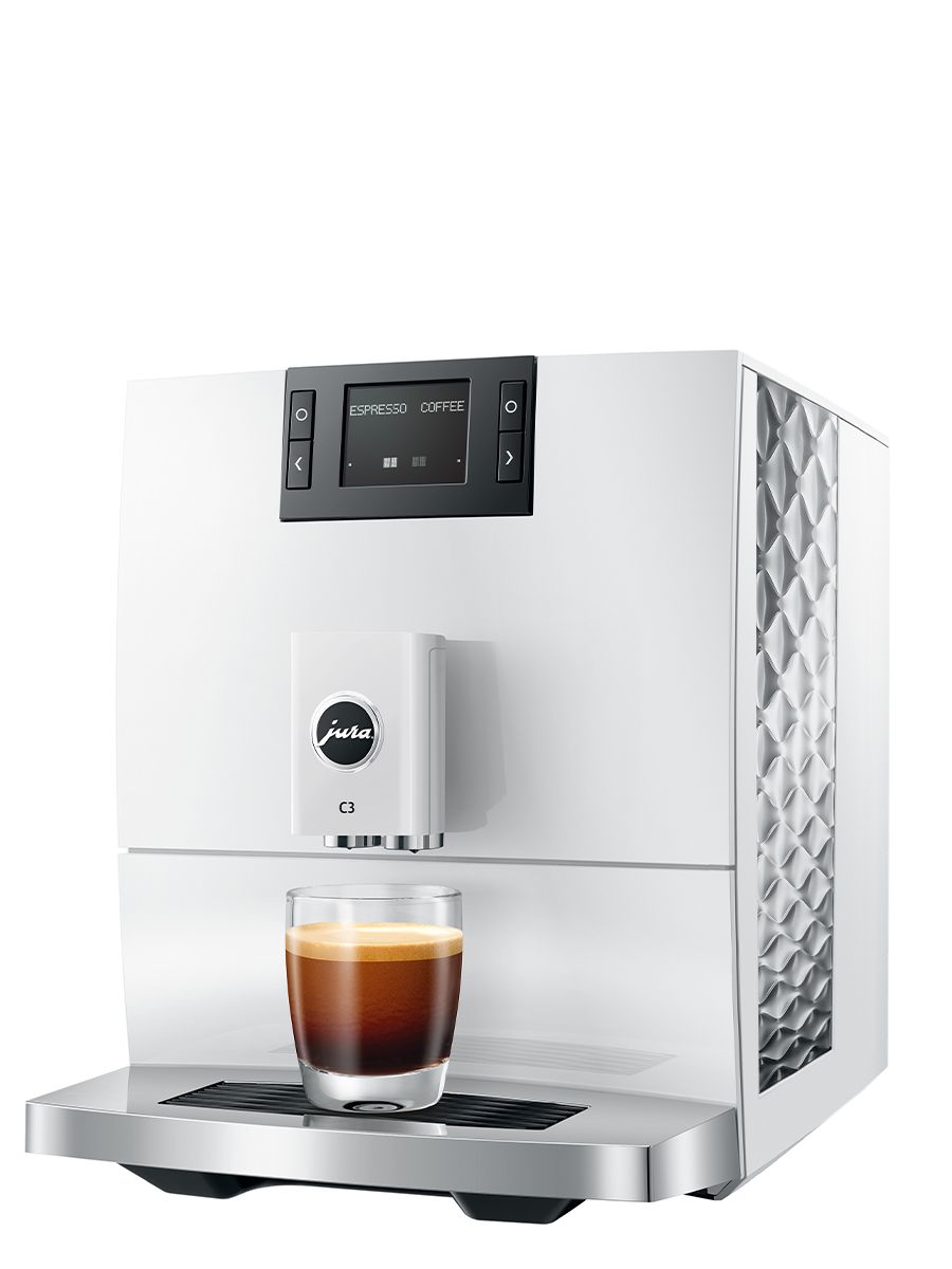 Angled front view of the JURA C3 Piano White coffee machine dispensing espresso into a single glass cup, with textured side panel visible.