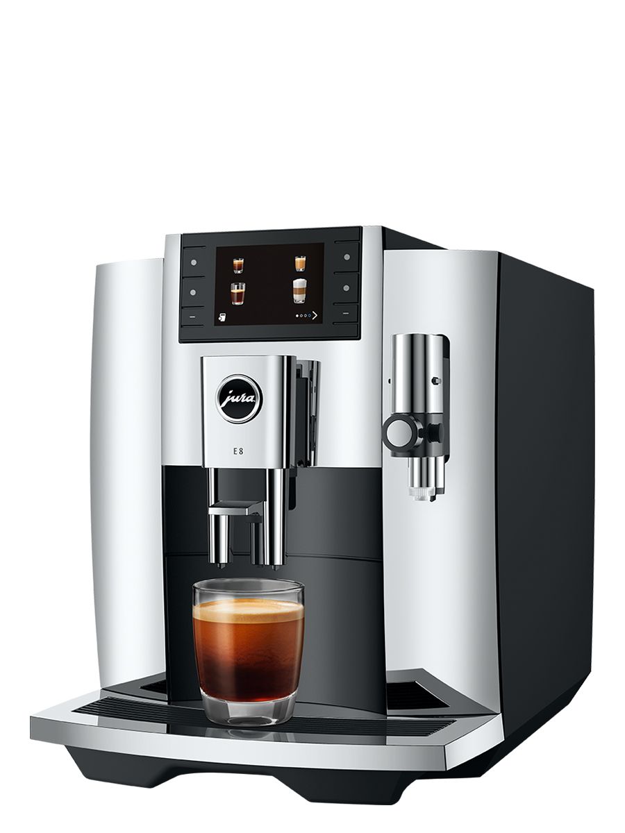 Side view of Jura E8 Chrome NAC espresso machine with coffee dispensing spout and cup beneath, showcasing its sleek black exterior and espresso preparation capability.