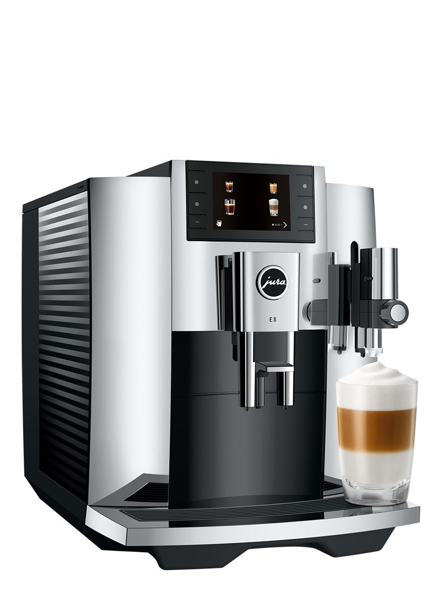 Side angle view of E8 Chrome showcasing the water tank, color display, and a Latte Macchiato in a glass cup