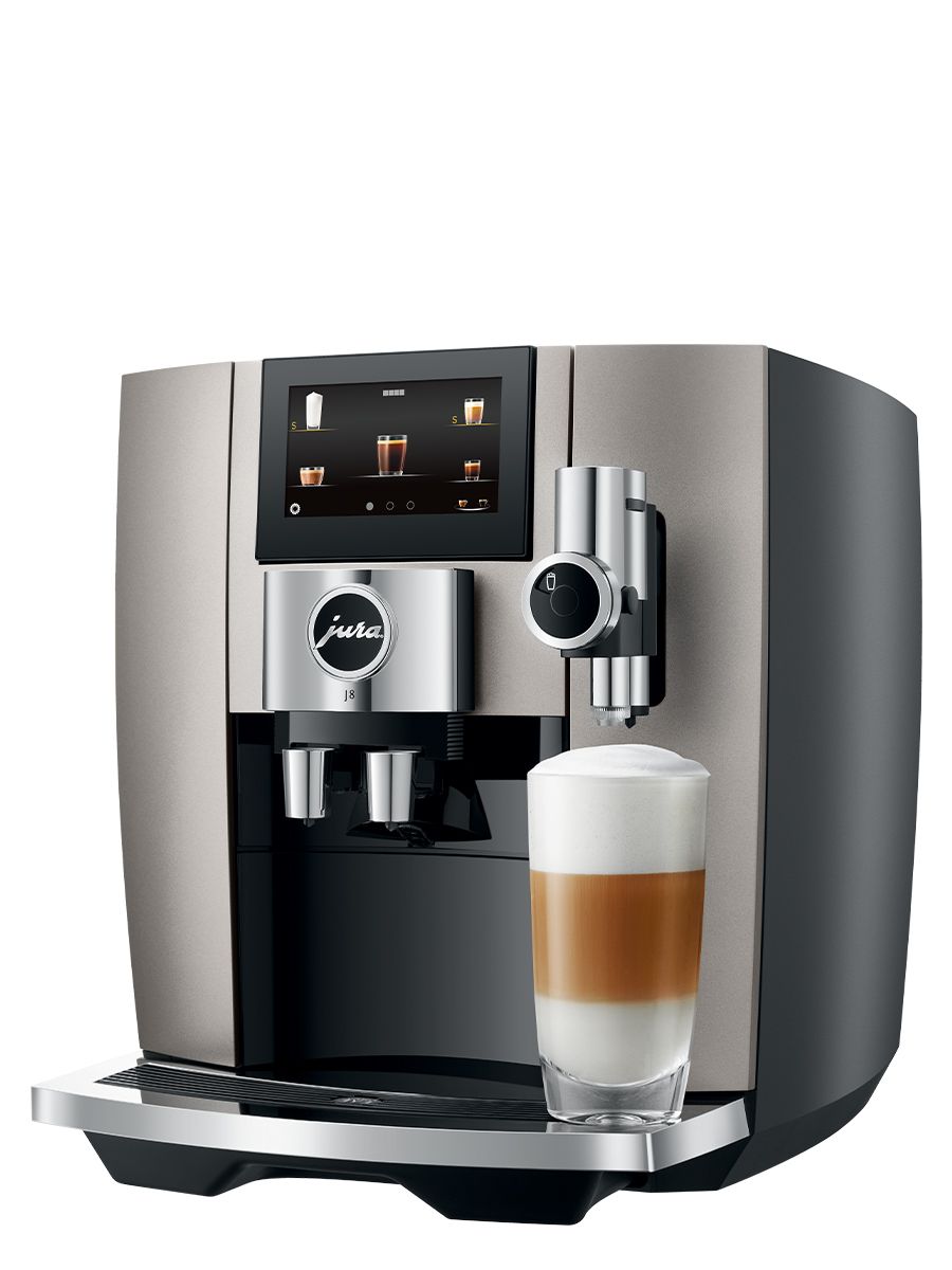 Left side view of J8 Midnight Silver featuring touchscreen display, drip tray, coffee spouts, with Latte Macchiato in a glass cup