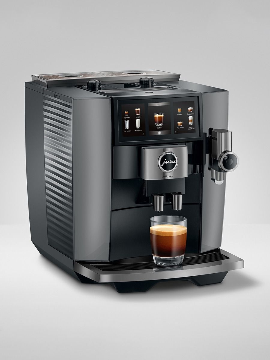 JURA J10 twin Diamond Onyx coffee machine with freshly brewed coffee in a glass cup