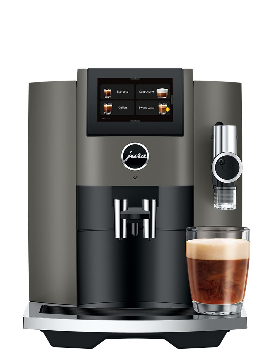 Front view of S8 Dark Inox including touchscreen display, coffee spouts, drip tray, with a sweet latte in a glass cup
