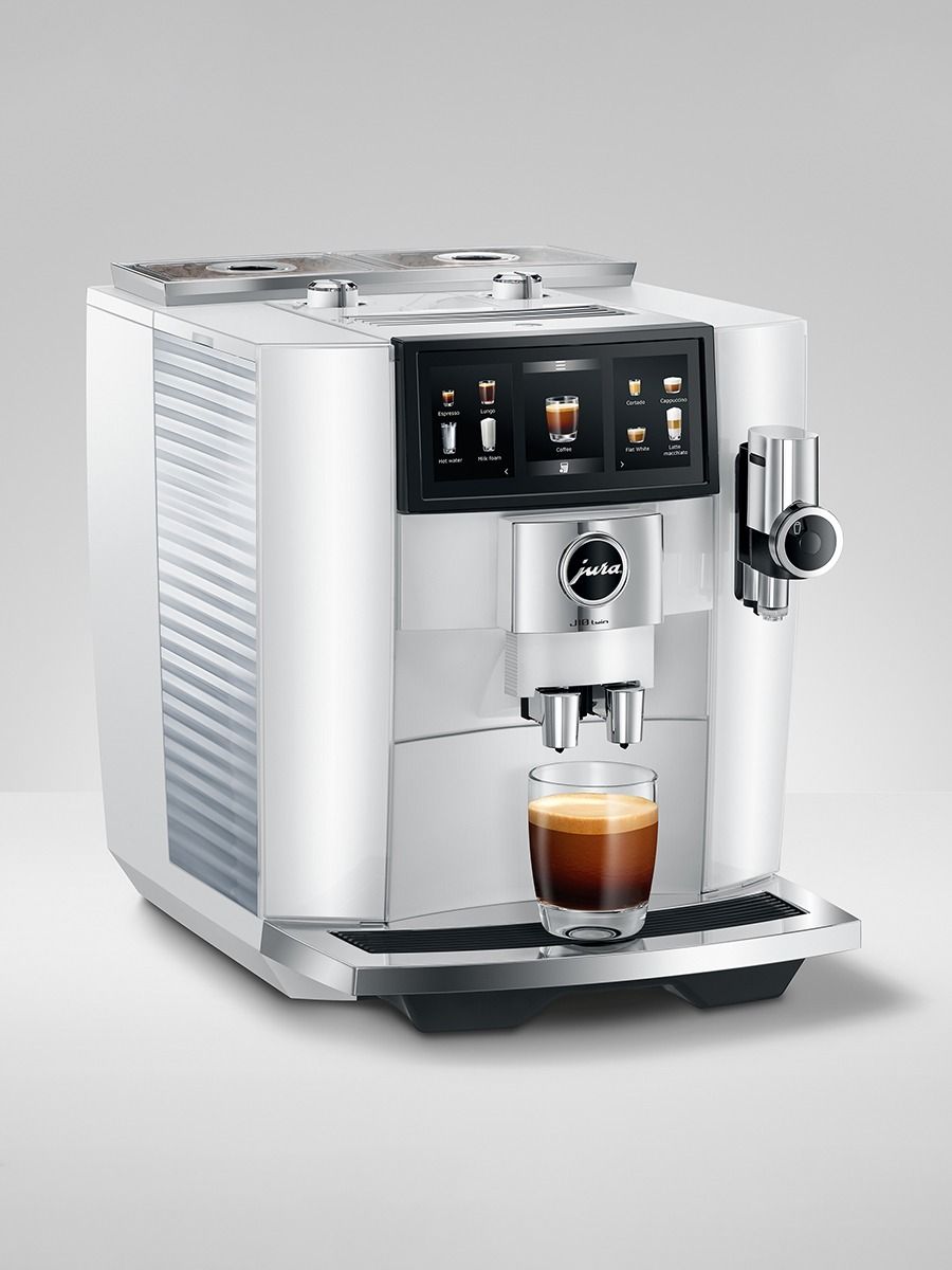 JURA J10 twin Diamond White coffee machine with freshly brewed coffee in a glass cup