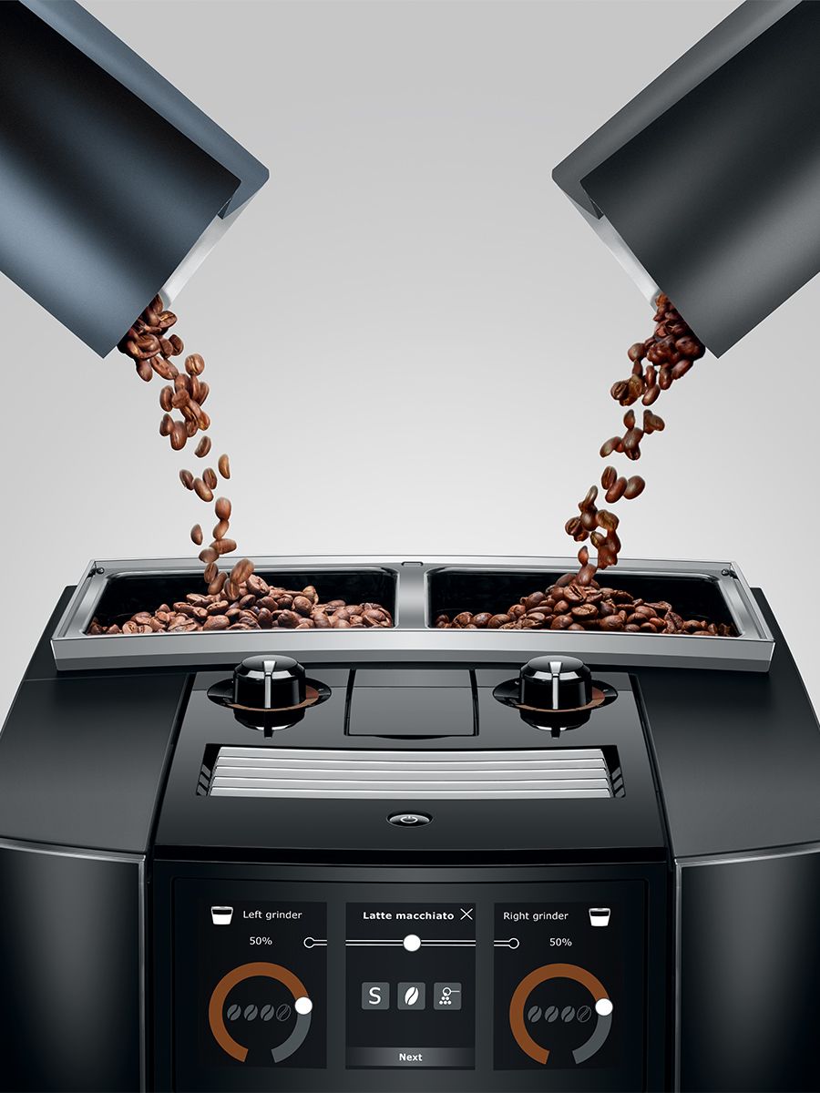 Close up of J8 twin Diamond Black two bean hoppers with two different coffees being poured into the hoppers