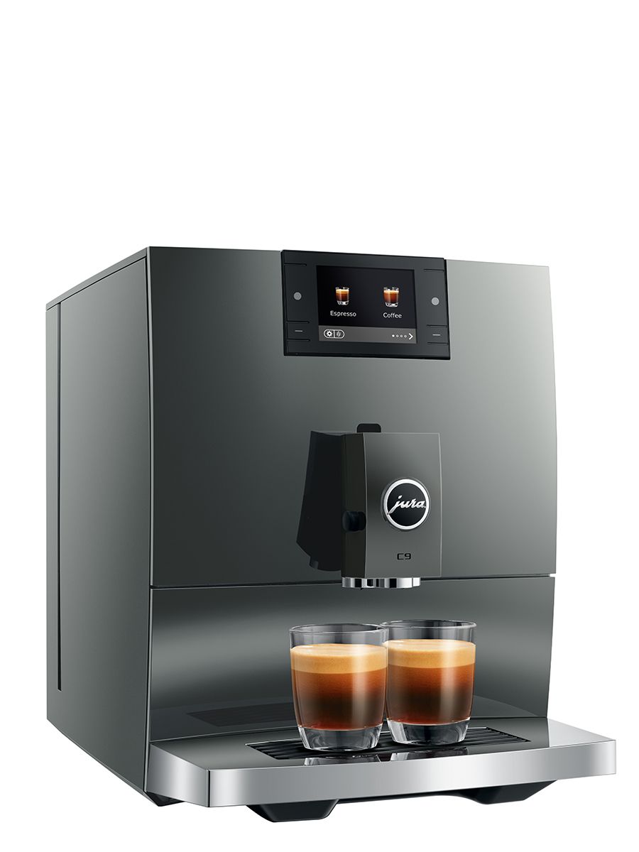 Angled front view of the JURA C9 Piano Inox coffee machine dispensing two espresso drinks into glass cups.