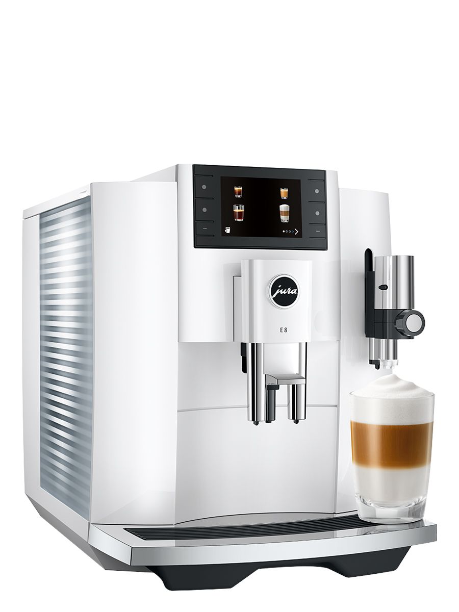 Side angle view of E8 piano White showcasing the water tank, color display, and a Latte Macchiato in a glass cup 