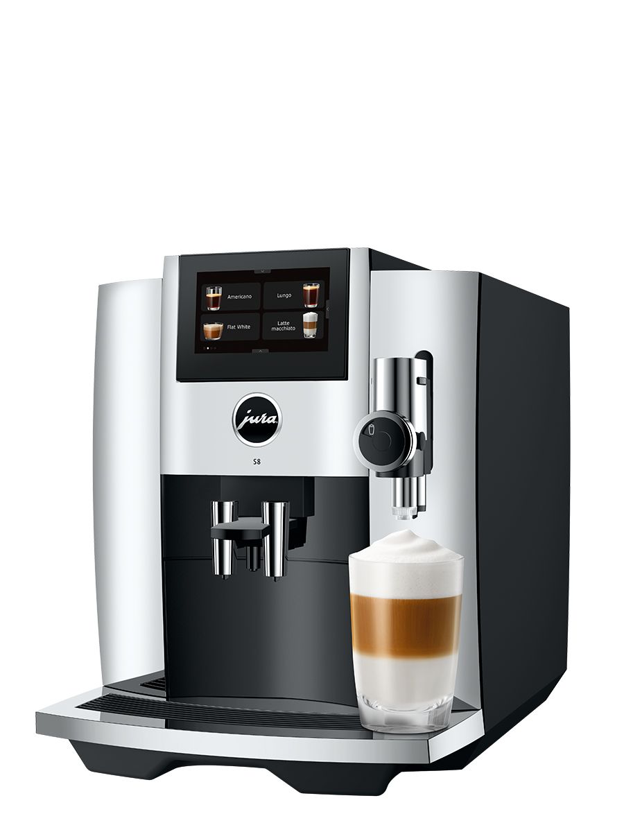 Left side view of S8 Chrome featuring touchscreen display, drip tray, coffee spouts, with Latte Macchiato in a glass cup